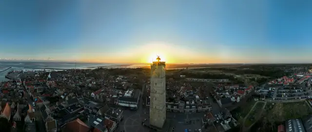 Aerial panorama of the Brandaris lighthouse above the village at sunset, Terschelling