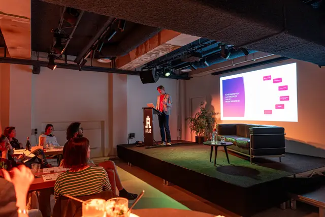 An event venue with a presentation screen.