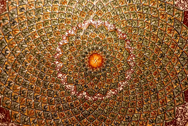 A close view of an ornate, mosaic-like hotel dome.