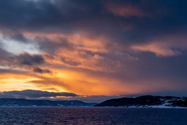 A dramatic sunset over a Norwegian fjord.